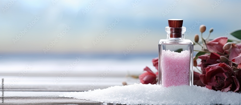 Poster a table displaying a bottle of rose essential oil alongside sea salt with plenty of copy space for a