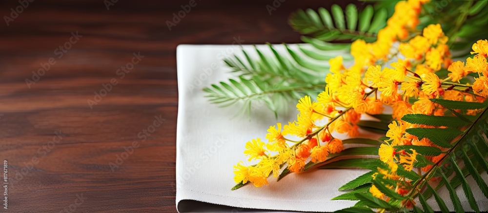 Poster Closeup of a mimosa branch and a napkin on a table creating a visually pleasing composition with plenty of copy space in the image