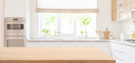 Empty dining table top in blurred interior of modern kitchen