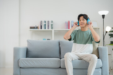 Relaxed young man enjoying music at home