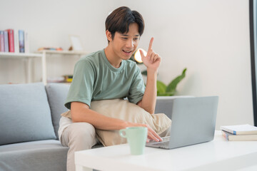 Thoughtful man using laptop at home