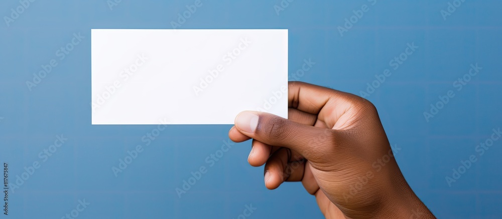 Fototapete A person s hand with a white card is captured in an image with a plain background creating space for adding something else. Creative banner. Copyspace image