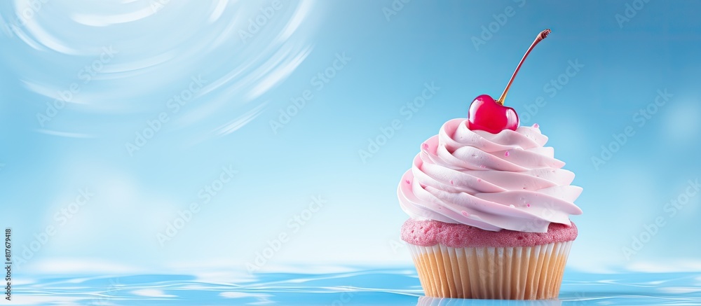 Poster copy space image of a solo cupcake adorned with swirls of pink icing and topped with a cherry agains