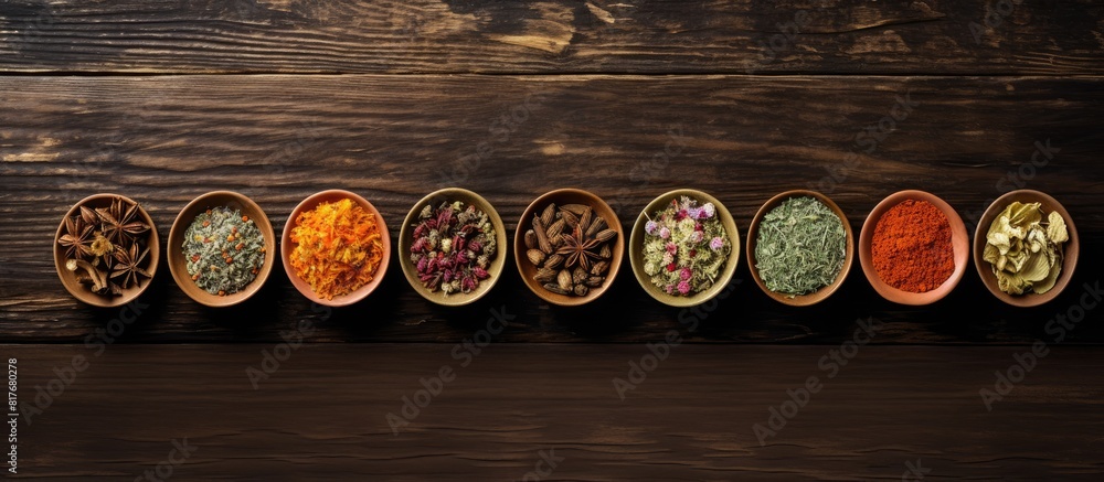 Poster Wooden background with various types of dry tea arranged in a flat lay composition creating a visually appealing copy space image