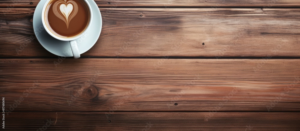 Leinwandbilder An aerial view of a wooden table with a coffee cup and a smartphone placed on it creating a suitable copy space image