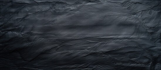 A textured black paper creating a backdrop for a copy space image