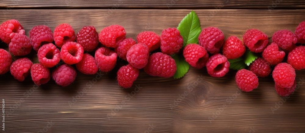 Poster A copy space image showcasing fresh raspberries displayed on a rustic wooden backdrop