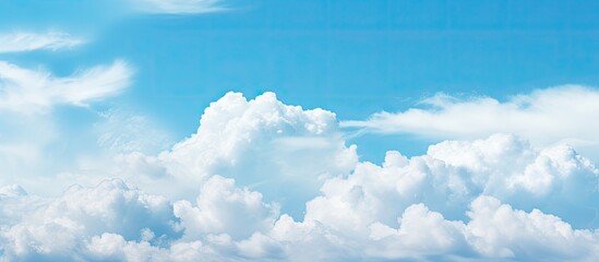 In spring a serene copy space image reveals a pale blue sky adorned with picturesque white fluffy clouds