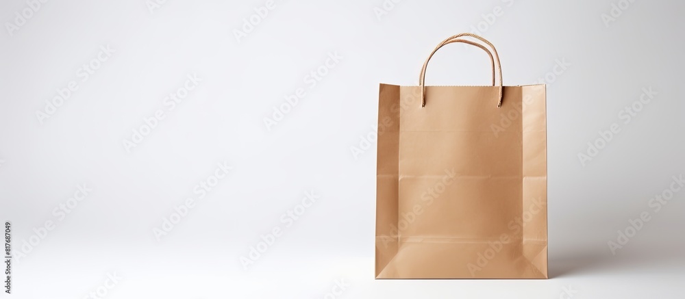 Aufkleber a small paper bag for shopping is shown on a white background providing copy space for additional co