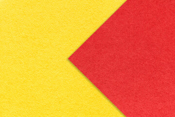 Texture of yellow paper background, half two colors with red arrow, macro. Structure of craft...