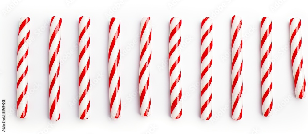 Poster a white background with red and white striped candy canes providing lots of copy space for any desig