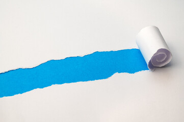 Colorful background, with torn and rolled white sheet
