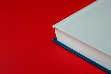 Blue bookmark with white book on red
