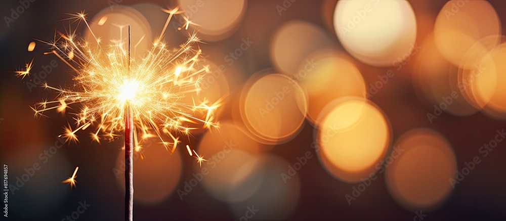 Poster blurred bokeh light background with a sparkler in the foreground creating a captivating copy space i