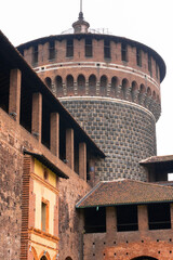 majestic medieval tower featuring prominent brickwork and arched openings, showcasing classical architecture