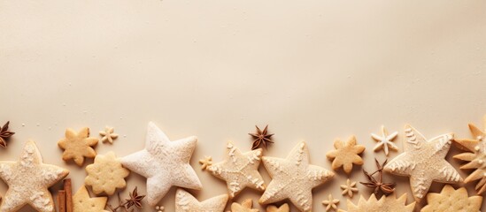 Christmas cookies and cutters arranged on a beige background with ample copy space for text or graphic elements in the image