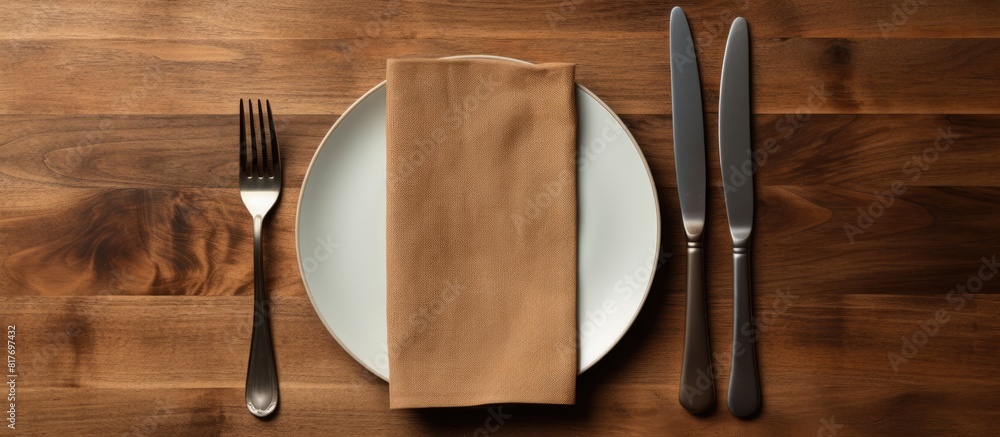 Aufkleber A top view of a table setting with an empty plate a knife a fork and a napkin providing ample copy space for customization