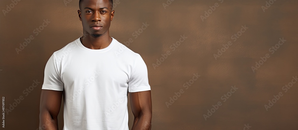 Wall mural handsome young african man wearing a t shirt appears uncertain on a plain background with room for t - Wall murals