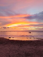 Stunning Sunset Beach Scene with Fiery Red-Orange Sky Over a Tranquil Tropical Sea 