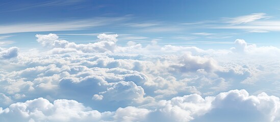 Fototapeta na wymiar A view from above of a sky filled with fluffy clouds Copy space image