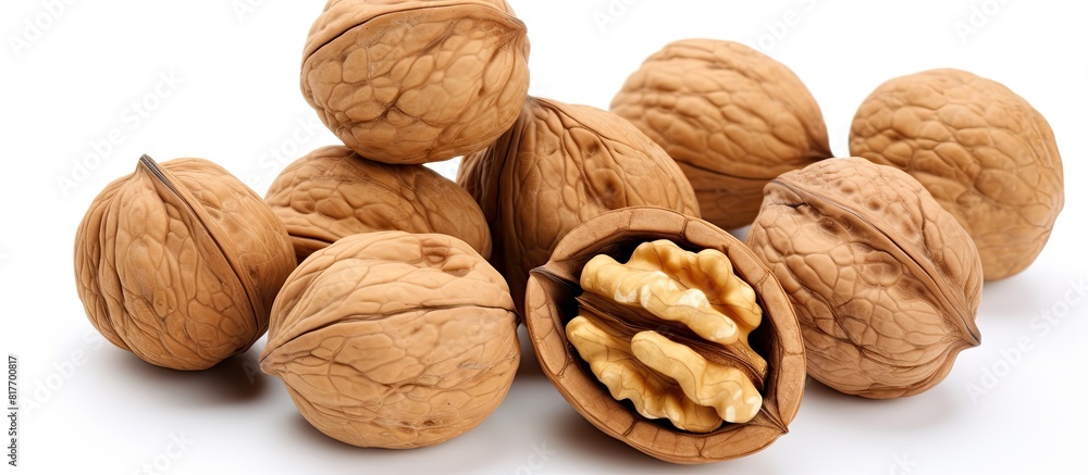 Poster A top view of a bowl of walnuts isolated on a white background providing copy space for adding text or images to the image