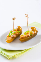 Pintxo of pickled gherkins with canned tuna. Vertical..