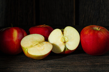 Four Polish red apples on a rustic background