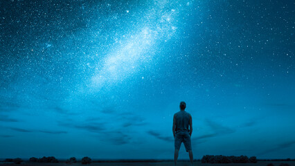 Person Stargazing Under a Starry Night Sky with the Milky Way