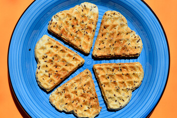 Homemade baked savory heart-shaped waffles on a blue plate