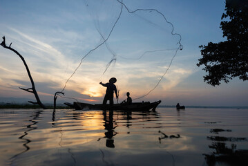 Fisherman of Lake in action when fishing, Thailand