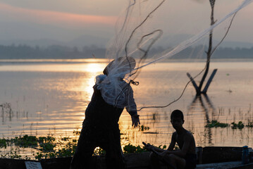 Fisherman of Lake in action when fishing, Thailand