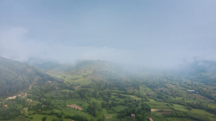 Landscape panorama using the Mini 2 drone, during a foggy morning. Beautiful green land and meadows.