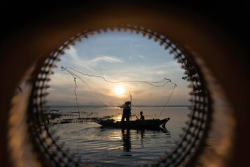 Fisherman of Lake in action when fishing, Thailand