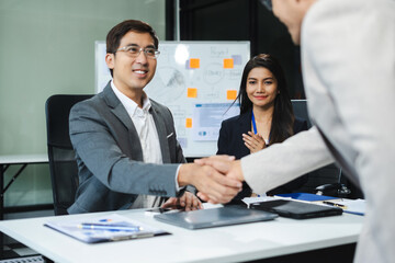 Group of Young Asian business team creative businesspeople coworker in office Happy to be successful partnership teamwork success concept.