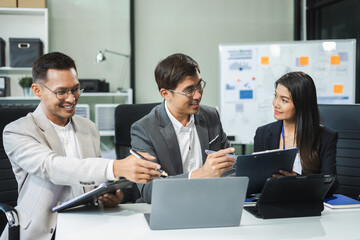 Group of Young Asian business team creative businesspeople coworker in office Happy to be successful partnership teamwork success concept.