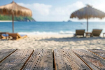 Wood table top with beach chairs and parasol on blurry beach background perfect for showcasing products