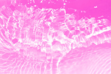  Pink water bubbles on the surface ripple. Defocus blurred transparent purple colored clear calm...