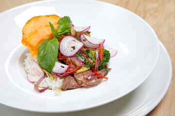 Rice topped with stir-fried beef and vegetables