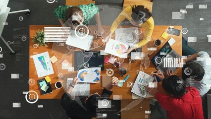 Top view of team brainstorming and looking tablet with coding program or engineering prompt. Group...