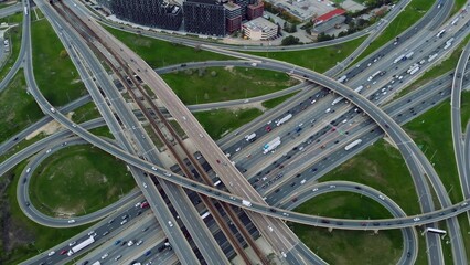 Urban veins: Drone footage over highway interlaced, reflecting non-stop flow of city traffic....