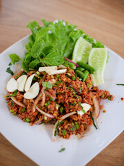 Raw meat beef cook, Spicy minced beef salad slice mixed with spices and herbs vegetable food of northeast Thailand style local.