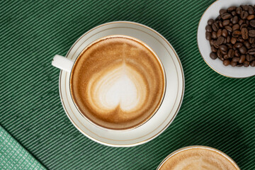 Steaming cup of cappuccino topped with foam
