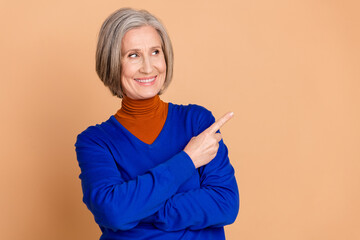 Photo portrait of lovely pensioner lady look point empty space dressed stylish blue garment...