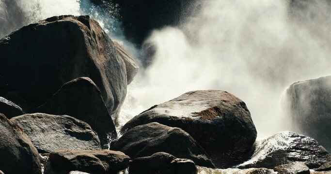 Scenic view of the water of a waterfall cascading on rocks making big splash on a sunny day