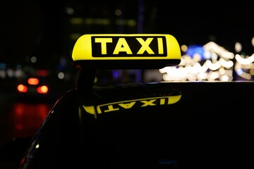 a yellow taxi sign sitting on the back of a vehicle