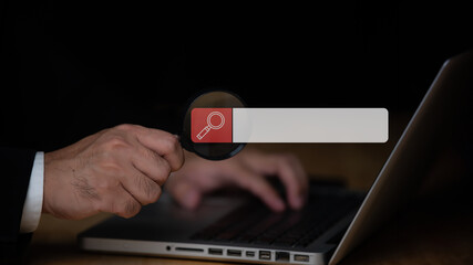 Businessman uses magnifying glass pointing at screen, Searching work on the internet concept,Technology Search Engine Optimization,Using Search Console with your website