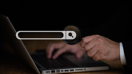 Businessman uses magnifying glass pointing at screen, Searching work on the internet concept,Technology Search Engine Optimization,Using Search Console with your website