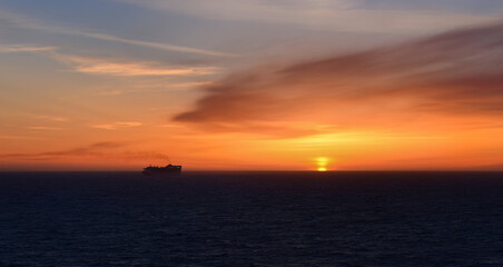 Fototapeta na wymiar Silhouette image of a cruise ship sailing at sunset. Alaska. USA.