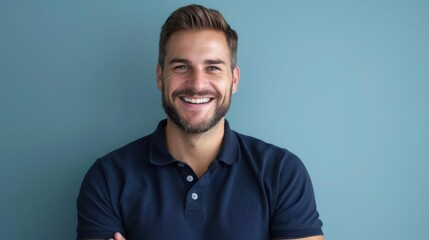 Man with a Big Smile, Looking Straight at Camera, Wearing Dark Blue Navy Polo, Light Blue Background, Perfect for Advertisements
