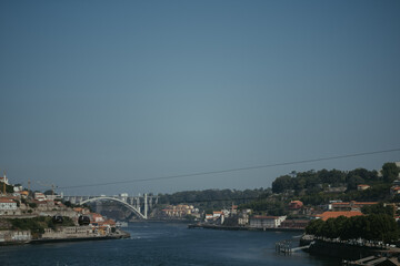 a river running between two small houses next to a city